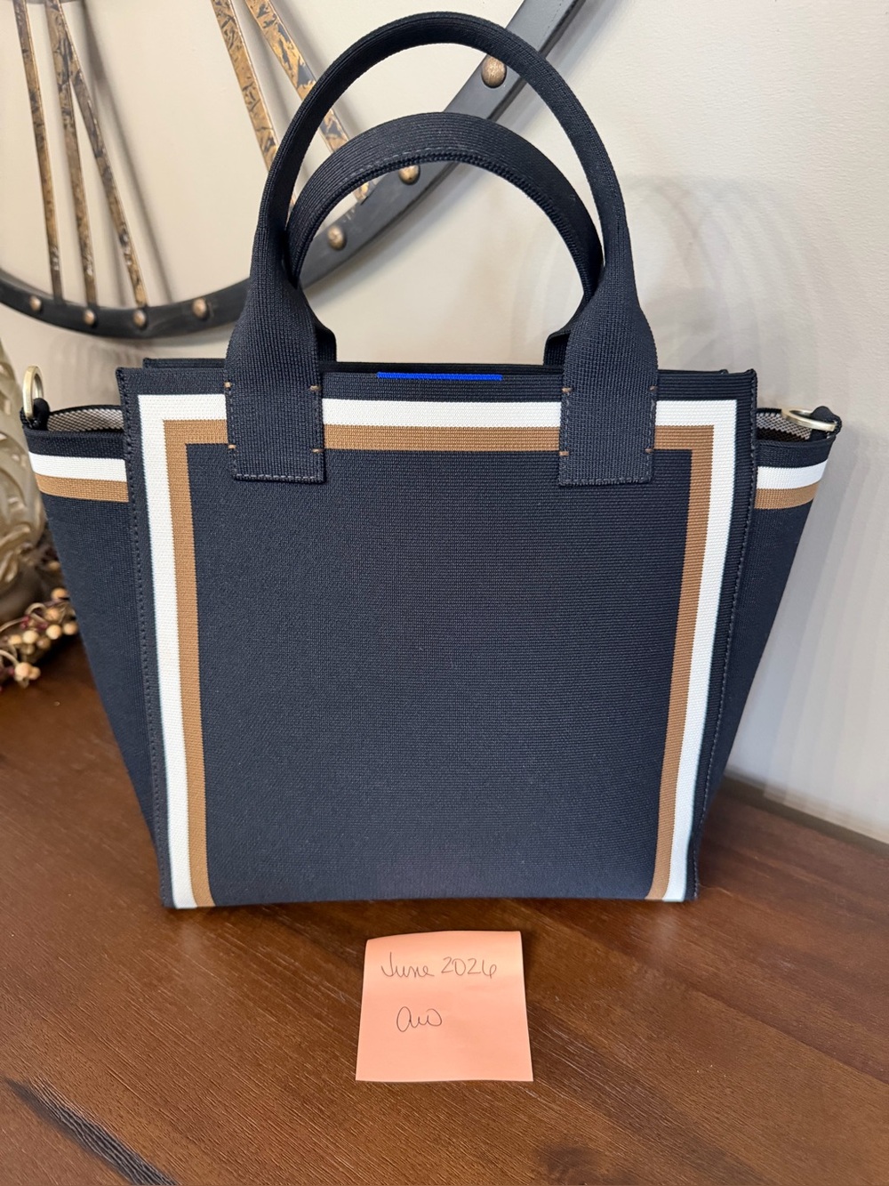 Black Rothy’s Tote with White and Brown Stripe Accent. Includes crossbody strap